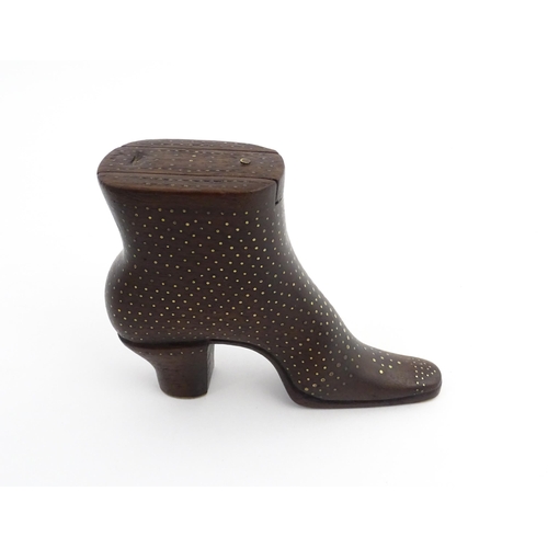 1197 - Treen : A carved shoe snuff box modelled as a heeled boot with sliding top and inlaid brass detail. ... 