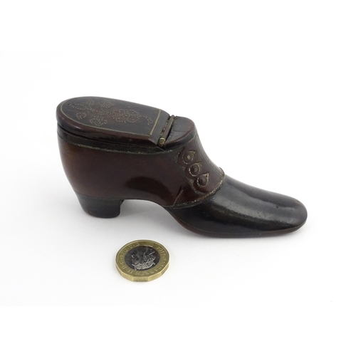 1198 - Treen : A carved snuff box modelled as a  heeled shoe with hinged lid and inlaid brass detail. Appro... 