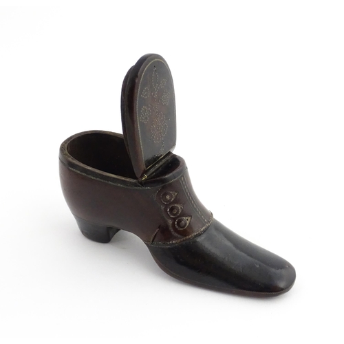 1198 - Treen : A carved snuff box modelled as a  heeled shoe with hinged lid and inlaid brass detail. Appro... 