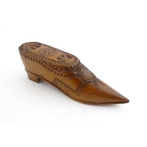 1199 - Treen : A 19thC Dutch snuff box of shoe form with sliding top and chip carved decoration. Approx. 4 ... 