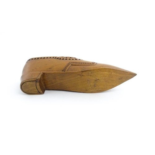 1199 - Treen : A 19thC Dutch snuff box of shoe form with sliding top and chip carved decoration. Approx. 4 ... 