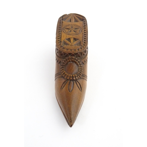 1199 - Treen : A 19thC Dutch snuff box of shoe form with sliding top and chip carved decoration. Approx. 4 ... 