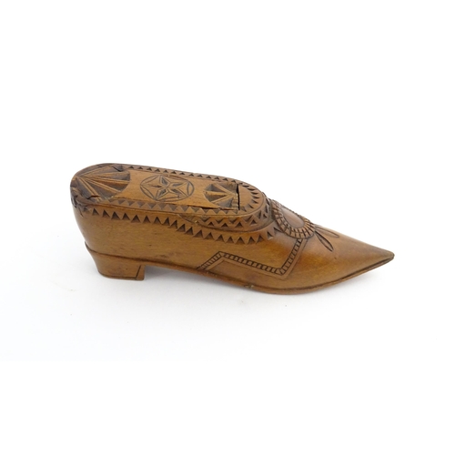 1199 - Treen : A 19thC Dutch snuff box of shoe form with sliding top and chip carved decoration. Approx. 4 ... 