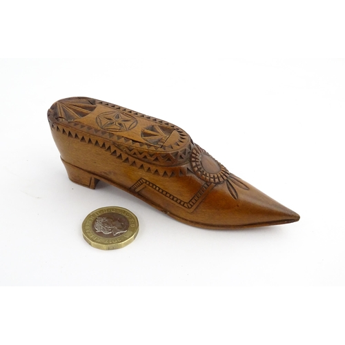 1199 - Treen : A 19thC Dutch snuff box of shoe form with sliding top and chip carved decoration. Approx. 4 ... 