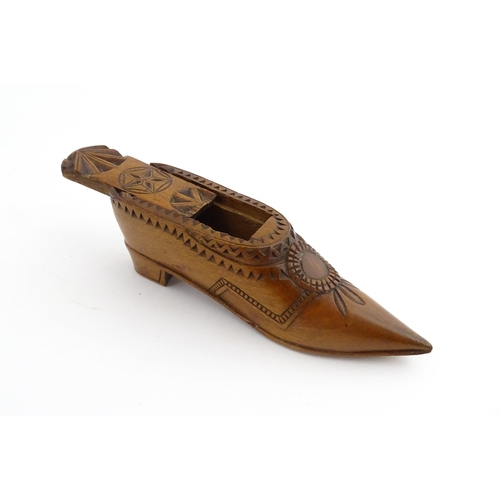 1199 - Treen : A 19thC Dutch snuff box of shoe form with sliding top and chip carved decoration. Approx. 4 ... 