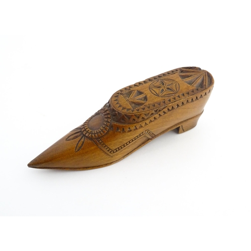 1199 - Treen : A 19thC Dutch snuff box of shoe form with sliding top and chip carved decoration. Approx. 4 ... 