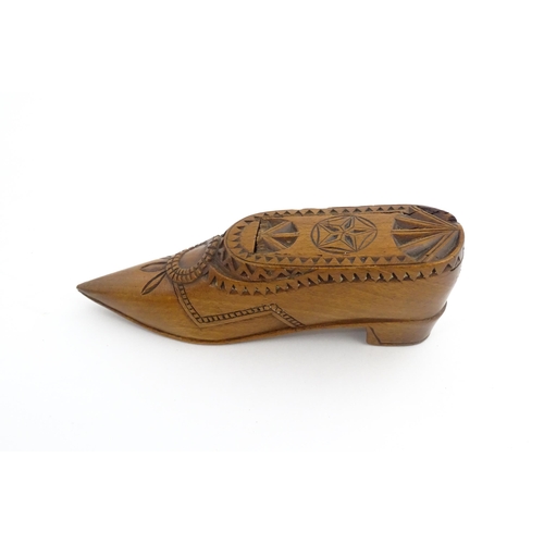 1199 - Treen : A 19thC Dutch snuff box of shoe form with sliding top and chip carved decoration. Approx. 4 ... 