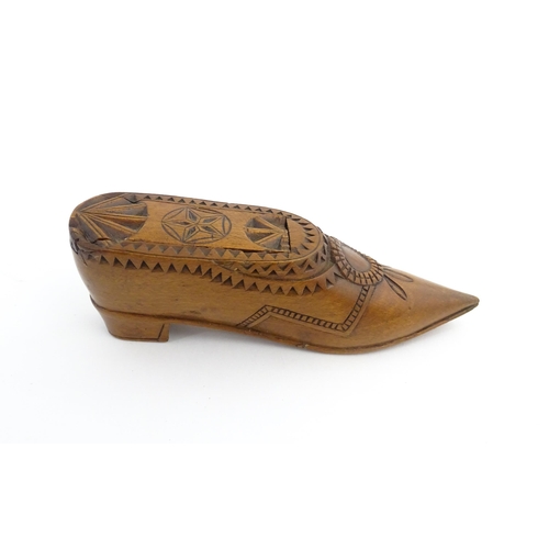 1199 - Treen : A 19thC Dutch snuff box of shoe form with sliding top and chip carved decoration. Approx. 4 ... 