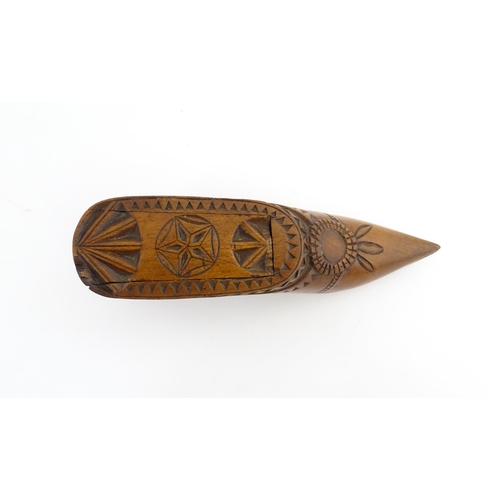 1199 - Treen : A 19thC Dutch snuff box of shoe form with sliding top and chip carved decoration. Approx. 4 ... 