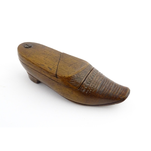 1202 - Treen : A 19thC Dutch novelty puzzle snuff box modelled as a shoe with carved decoration. Approx. 3 ... 