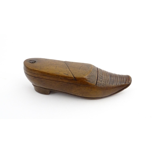 1202 - Treen : A 19thC Dutch novelty puzzle snuff box modelled as a shoe with carved decoration. Approx. 3 ... 