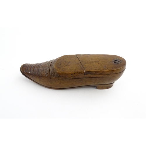 1202 - Treen : A 19thC Dutch novelty puzzle snuff box modelled as a shoe with carved decoration. Approx. 3 ... 