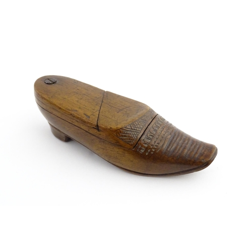 1202 - Treen : A 19thC Dutch novelty puzzle snuff box modelled as a shoe with carved decoration. Approx. 3 ... 