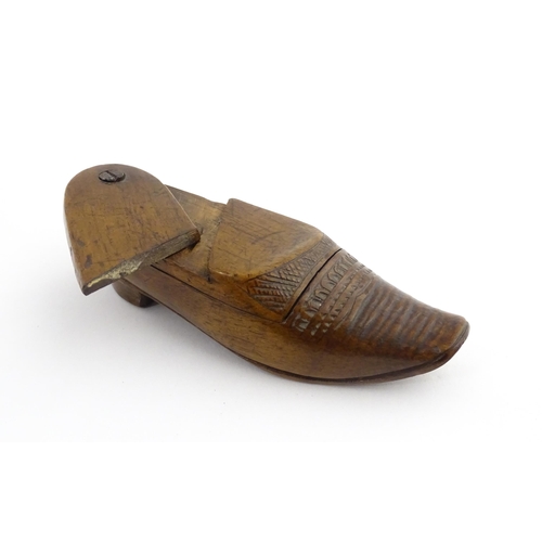 1202 - Treen : A 19thC Dutch novelty puzzle snuff box modelled as a shoe with carved decoration. Approx. 3 ... 