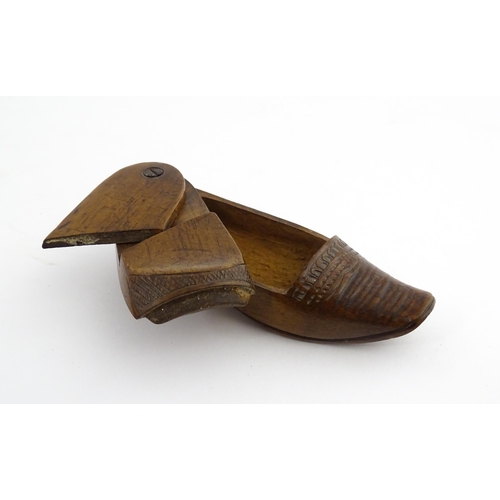 1202 - Treen : A 19thC Dutch novelty puzzle snuff box modelled as a shoe with carved decoration. Approx. 3 ... 