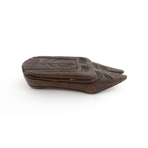 1203 - Treen : A 19thC double shoe snuff box modelled as a pair of shoes with sliding top and carved decora... 