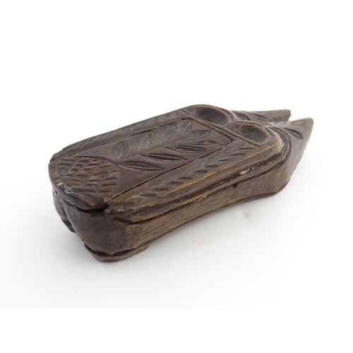 1203 - Treen : A 19thC double shoe snuff box modelled as a pair of shoes with sliding top and carved decora... 