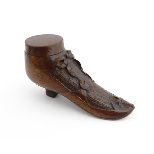 1205 - Treen : A 19thC shoe snuff box modelled as a ladies shoe with carved bow and flower detail. Approx. ... 