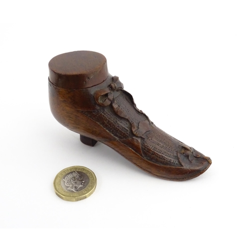 1205 - Treen : A 19thC shoe snuff box modelled as a ladies shoe with carved bow and flower detail. Approx. ... 