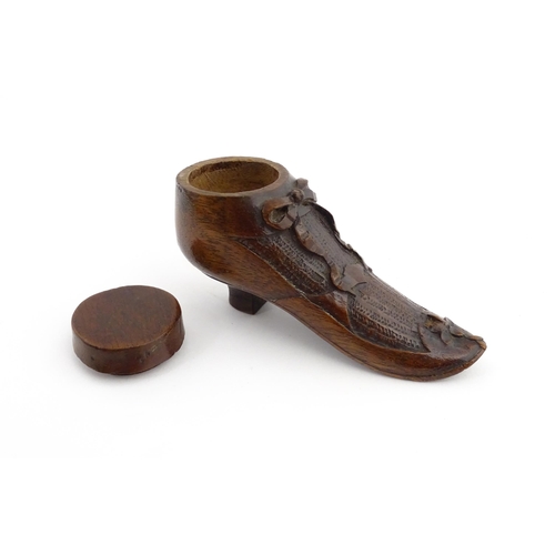 1205 - Treen : A 19thC shoe snuff box modelled as a ladies shoe with carved bow and flower detail. Approx. ... 