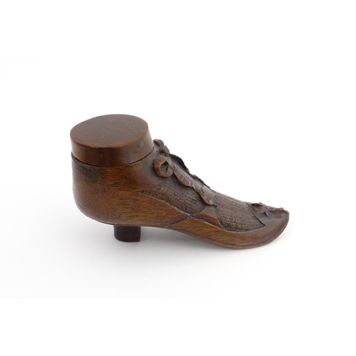 1205 - Treen : A 19thC shoe snuff box modelled as a ladies shoe with carved bow and flower detail. Approx. ... 