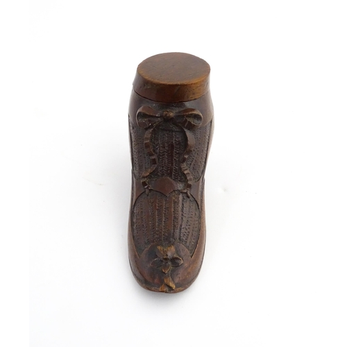 1205 - Treen : A 19thC shoe snuff box modelled as a ladies shoe with carved bow and flower detail. Approx. ... 