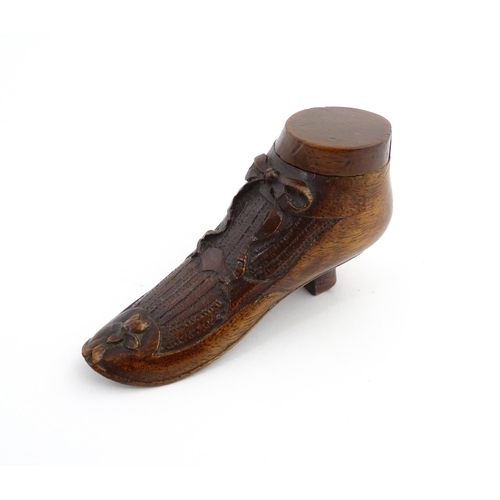 1205 - Treen : A 19thC shoe snuff box modelled as a ladies shoe with carved bow and flower detail. Approx. ... 