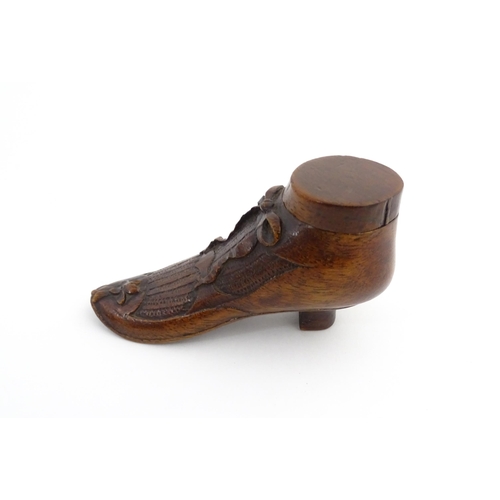 1205 - Treen : A 19thC shoe snuff box modelled as a ladies shoe with carved bow and flower detail. Approx. ... 