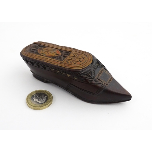 1206 - Treen : A 19thC Continental shoe snuff box with sliding top, chip carved decoration and painted deta... 