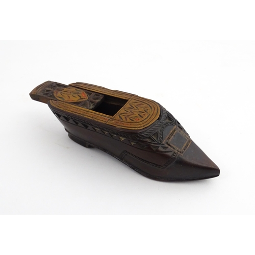 1206 - Treen : A 19thC Continental shoe snuff box with sliding top, chip carved decoration and painted deta... 