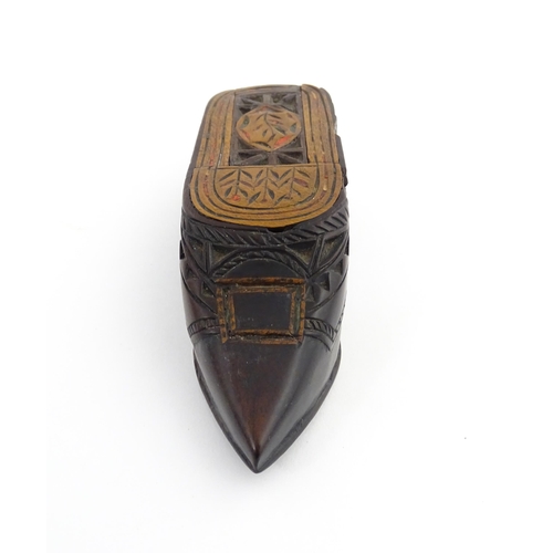 1206 - Treen : A 19thC Continental shoe snuff box with sliding top, chip carved decoration and painted deta... 