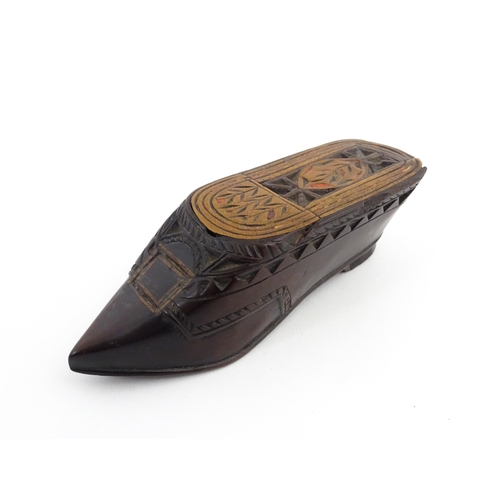 1206 - Treen : A 19thC Continental shoe snuff box with sliding top, chip carved decoration and painted deta... 