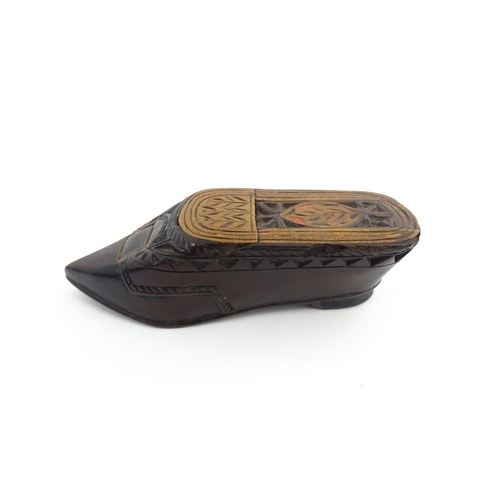 1206 - Treen : A 19thC Continental shoe snuff box with sliding top, chip carved decoration and painted deta... 