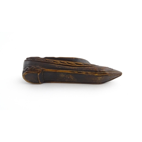 1211 - Treen : A 19thC Continental shoe snuff box with sliding top and carved foliate decoration. Approx. 3... 