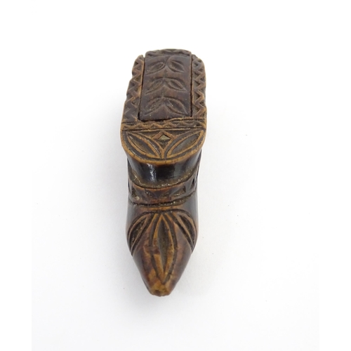 1211 - Treen : A 19thC Continental shoe snuff box with sliding top and carved foliate decoration. Approx. 3... 