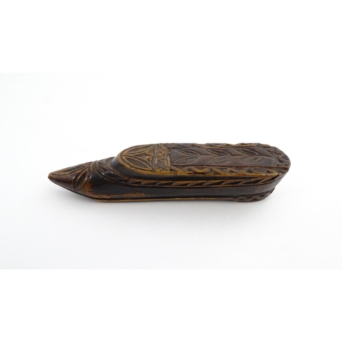 1211 - Treen : A 19thC Continental shoe snuff box with sliding top and carved foliate decoration. Approx. 3... 