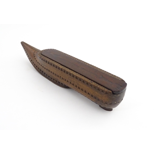 1212 - Treen : A 19thC carved wooden box of large shoe snuff form with chip carved decoration and sliding t... 