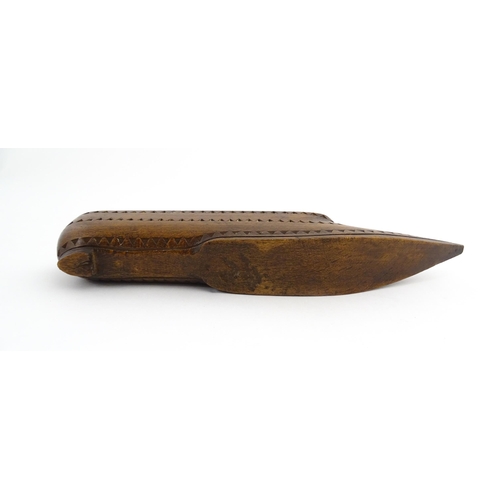 1212 - Treen : A 19thC carved wooden box of large shoe snuff form with chip carved decoration and sliding t... 