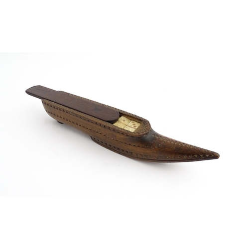 1212 - Treen : A 19thC carved wooden box of large shoe snuff form with chip carved decoration and sliding t... 