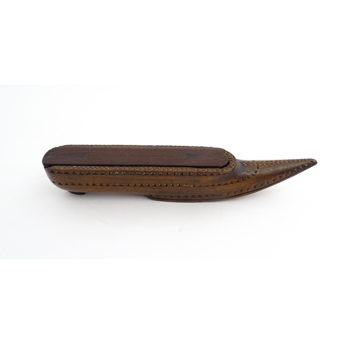 1212 - Treen : A 19thC carved wooden box of large shoe snuff form with chip carved decoration and sliding t... 