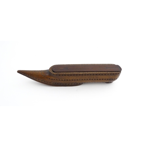 1212 - Treen : A 19thC carved wooden box of large shoe snuff form with chip carved decoration and sliding t... 