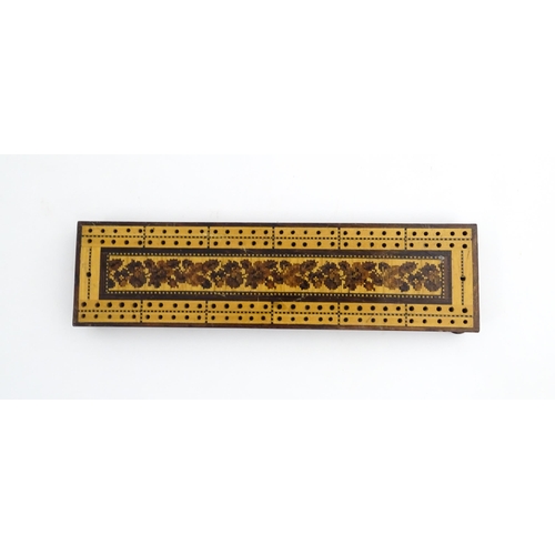 1214 - Treen: Three Tunbridge ware cribbage boards with central floral decoration. Largest approx. 10