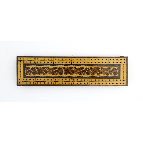 1214 - Treen: Three Tunbridge ware cribbage boards with central floral decoration. Largest approx. 10