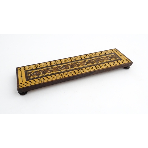 1214 - Treen: Three Tunbridge ware cribbage boards with central floral decoration. Largest approx. 10