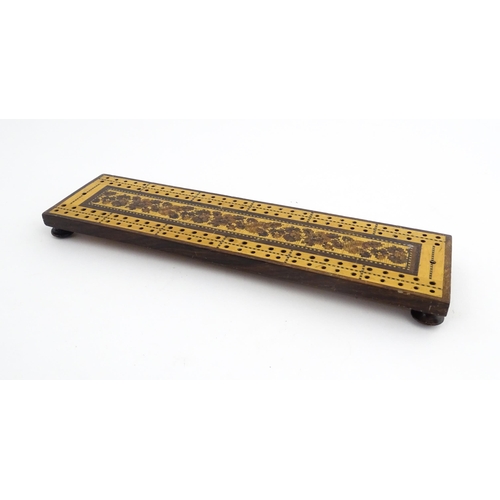 1214 - Treen: Three Tunbridge ware cribbage boards with central floral decoration. Largest approx. 10