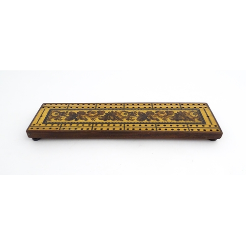 1214 - Treen: Three Tunbridge ware cribbage boards with central floral decoration. Largest approx. 10