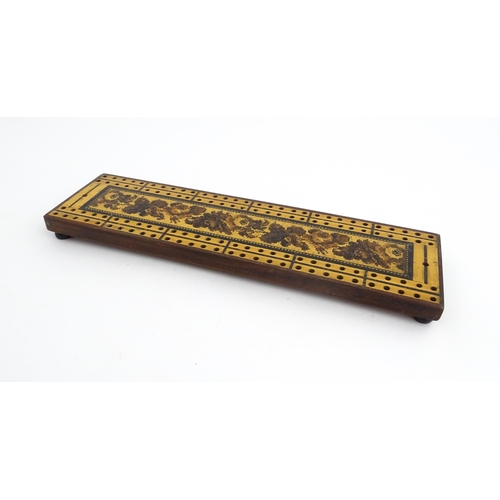 1214 - Treen: Three Tunbridge ware cribbage boards with central floral decoration. Largest approx. 10