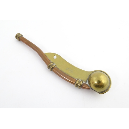 1216 - A 20thC brass and copper Bosun's whistle, engraved Simon Wood. Approx. 4 1/2