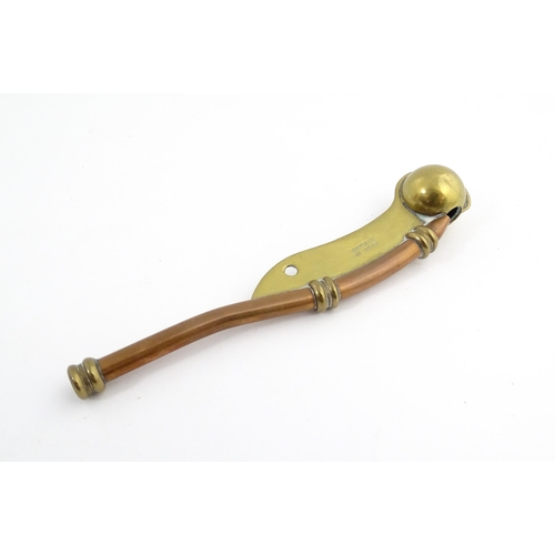 1216 - A 20thC brass and copper Bosun's whistle, engraved Simon Wood. Approx. 4 1/2