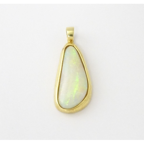 604 - A 14ct gold pendant set with central opal. Approx. 1 1/4